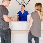 Man and Women at Dentist Office Front Desk
